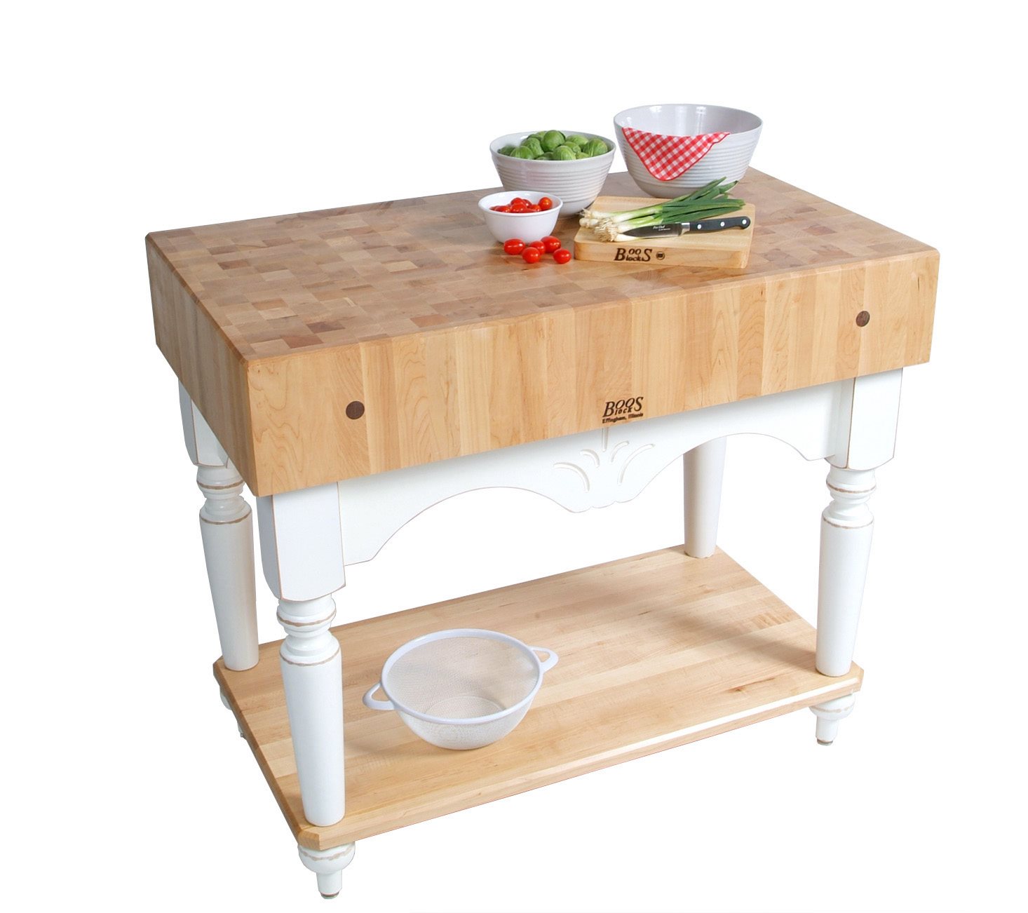 Maple end-grain butcher block table with a white base, turned legs and a lower shelf holding a colander