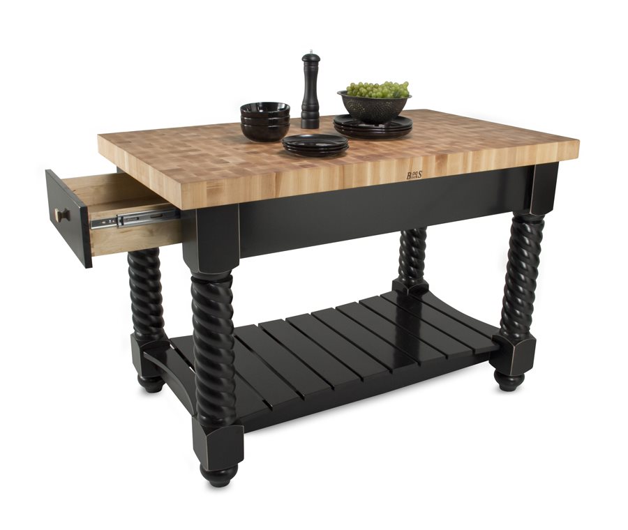 End-grain maple butcher block island with black base, barley-twist legs, slatted shelf and a partly open drawer